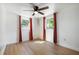 Bright bedroom features laminate flooring, modern ceiling fan, and lots of natural light at 4112 Alafia Blvd, Brandon, FL 33511