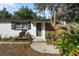 Charming home featuring a colorful green front door, neutral facade, and flourishing plants at 4112 Alafia Blvd, Brandon, FL 33511