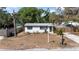 Front exterior of charming home featuring well-maintained landscape and white picket fence at 4112 Alafia Blvd, Brandon, FL 33511
