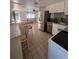Open kitchen featuring stainless steel appliances, white cabinets and hardware, and a dining area at 4112 Alafia Blvd, Brandon, FL 33511