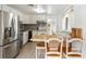 Bright kitchen featuring stainless steel appliances, white cabinetry, and a built-in breakfast bar at 4112 Alafia Blvd, Brandon, FL 33511