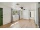 Bright living room with laminate flooring, modern ceiling fan, and an exterior door at 4112 Alafia Blvd, Brandon, FL 33511
