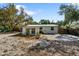 Rear exterior view of the home with a concrete parking space and fenced perimeter at 4112 Alafia Blvd, Brandon, FL 33511