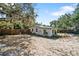 Rear exterior of home showing large fenced in yard surrounded with mature trees at 4112 Alafia Blvd, Brandon, FL 33511