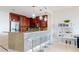 Modern kitchen features granite counters, stainless appliances, wine rack, and stylish pendant lighting at 450 Knights Run Ave # 703, Tampa, FL 33602