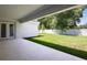 The covered patio overlooks a manicured lawn and a privacy fence in this spacious backyard at 4517 Foley Grove Dr, Valrico, FL 33596
