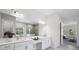 Bright bathroom featuring dual vanities, quartz countertops, and a large mirror at 4517 Foley Grove Dr, Valrico, FL 33596