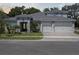 Charming single-Gathering home featuring a manicured lawn and a three-car garage at 4517 Foley Grove Dr, Valrico, FL 33596
