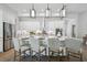 Well-lit eat-in kitchen features a center island, stainless steel appliances and white cabinets for storage at 4517 Foley Grove Dr, Valrico, FL 33596