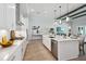 Bright white kitchen features a large island, stainless steel appliances, and modern lighting at 4517 Foley Grove Dr, Valrico, FL 33596