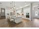 Stylish modern eat-in kitchen features a large island with seating, stainless steel appliances, and light wood floors at 4517 Foley Grove Dr, Valrico, FL 33596