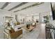 Open-concept living space with high ceilings, wooden beams, hardwood floors, and great natural light at 4517 Foley Grove Dr, Valrico, FL 33596