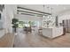 Open-concept living room and kitchen with bright natural light, wooden beams and plenty of open floor space at 4517 Foley Grove Dr, Valrico, FL 33596