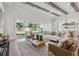 Bright living room features contemporary furniture, a tray ceiling, and a seamless transition to the outdoors at 4517 Foley Grove Dr, Valrico, FL 33596