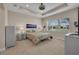 Comfortable bedroom boasts neutral walls, tray ceiling, neutral carpet and views of the outdoors at 4931 Sevilla Shores Dr, Wimauma, FL 33598