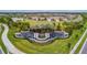 Aerial view of the community entrance with landscaped grounds and decorative water features at 4931 Sevilla Shores Dr, Wimauma, FL 33598