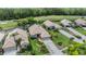 Aerial view of residences with lush landscaping, tile roofs, and golf course and pond views at 5132 Pinnacle Dr, Oldsmar, FL 34677