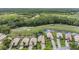 Aerial view of homes nestled beside a lush golf course and waterway, surrounded by trees at 5132 Pinnacle Dr, Oldsmar, FL 34677