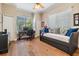 Bedroom featuring hardwood floors, a day bed, and a built-in desk at 5132 Pinnacle Dr, Oldsmar, FL 34677