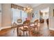 Formal dining room with a chandelier and sheer curtains, creating an elegant dining experience at 5132 Pinnacle Dr, Oldsmar, FL 34677