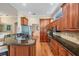 Well-appointed kitchen featuring custom wood cabinets, granite countertops, and modern appliances at 5132 Pinnacle Dr, Oldsmar, FL 34677