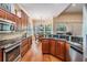 Gourmet kitchen featuring wooden cabinetry, granite countertops, and stainless steel appliances at 5132 Pinnacle Dr, Oldsmar, FL 34677