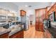 Spacious kitchen with wood cabinets, granite counters, stainless appliances, and hardwood flooring at 5132 Pinnacle Dr, Oldsmar, FL 34677