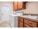 Well-organized laundry room with wooden cabinets, utility sink, and modern washer and dryer for convenient home chores at 5132 Pinnacle Dr, Oldsmar, FL 34677