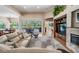 Open-concept living room with fireplace and backyard views, creating a warm and inviting space at 5132 Pinnacle Dr, Oldsmar, FL 34677
