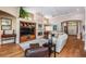 Spacious living room with hardwood floors, a fireplace, and built-in shelving at 5132 Pinnacle Dr, Oldsmar, FL 34677