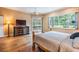Bright main bedroom with hardwood floors and views of the pool and backyard at 5132 Pinnacle Dr, Oldsmar, FL 34677