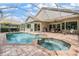 Beautiful screened-in pool and spa area with patio seating, offering a relaxing outdoor living space at 5132 Pinnacle Dr, Oldsmar, FL 34677