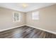 Cozy bedroom with wood look floors and windows that bring in natural light at 518 62Nd Ne Ave, St Petersburg, FL 33702