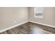 Bright bedroom with window and wood-look floors, perfect for relaxation at 518 62Nd Ne Ave, St Petersburg, FL 33702