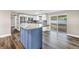 Modern kitchen with stainless appliances, center island, and sliding glass doors to the backyard at 518 62Nd Ne Ave, St Petersburg, FL 33702