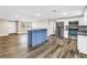 Open concept kitchen features blue island, stainless appliances, and recessed lighting at 518 62Nd Ne Ave, St Petersburg, FL 33702