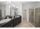 Sleek bathroom featuring double sinks, a glass-enclosed shower, and modern fixtures at 5312 6Th N Way, St Petersburg, FL 33703