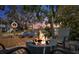 Outdoor living space with a fire pit and seating area overlooking waterfront at dusk at 5341 Circle Dr, Weeki Wachee, FL 34607