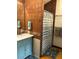 Bathroom with copper-colored tile walls, cabinet sink, and tub shower at 5341 Circle Dr, Weeki Wachee, FL 34607