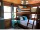 Charming bedroom featuring a wooden bunk bed and stylish turquoise accents at 5341 Circle Dr, Weeki Wachee, FL 34607