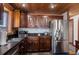 Beautiful kitchen with stainless steel appliances, dark wood cabinets, granite countertops, and stylish backsplash at 5341 Circle Dr, Weeki Wachee, FL 34607