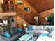 Vaulted wood ceiling living room with stone accents, two sofas, and decor at 5341 Circle Dr, Weeki Wachee, FL 34607