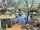 Scenic water view featuring a dock, boats, and lush greenery on a sunny day at 5341 Circle Dr, Weeki Wachee, FL 34607