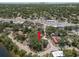 Aerial shot of a home nestled in a tree-filled landscape, with water views and a city skyline on the horizon at 5415 Park Pl, Tampa, FL 33603