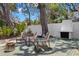 Outdoor living space with wood chairs, a fireplace, and a lush, green yard for enjoyment at 5415 Park Pl, Tampa, FL 33603