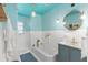 Charming bathroom featuring blue tile accents and modern fixtures at 5415 Park Pl, Tampa, FL 33603