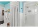 Bright bathroom with a white tiled shower and a glass shower door at 5415 Park Pl, Tampa, FL 33603