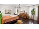 Bedroom with dark hardwood floors, chandelier, and windows providing natural light at 5415 Park Pl, Tampa, FL 33603