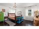 Cozy bedroom with dark hardwood floors and ample natural light from bright windows at 5415 Park Pl, Tampa, FL 33603