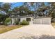 Exterior of this home showing a large driveway with an attached two-car garage at 5415 Park Pl, Tampa, FL 33603